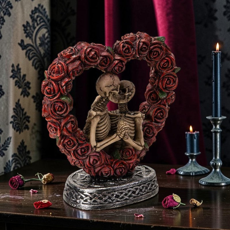 Halloween-Emporium Love Never Dies resin figurine featuring two skeletons embracing inside a red rose heart frame.