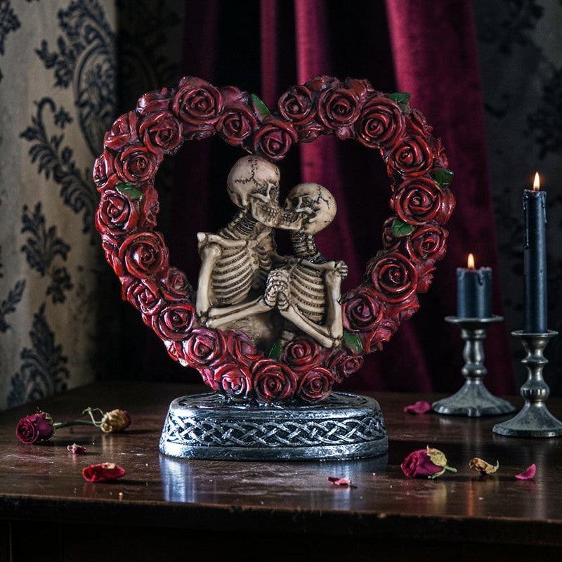 Halloween-Emporium Love Never Dies resin figurine featuring two skeletons embracing inside a red rose heart on a base.