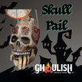 Halloween-Emporium Ghoulish Productions skull trick-or-treat pail with weathered bone texture and red accents.