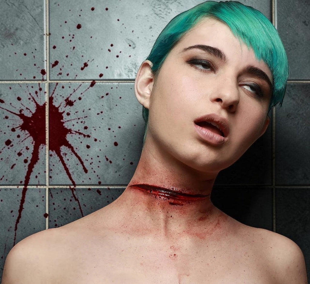 Halloween-Emporium latex slit throat SFX appliance on a model with teal hair against a blood-splattered tiled wall