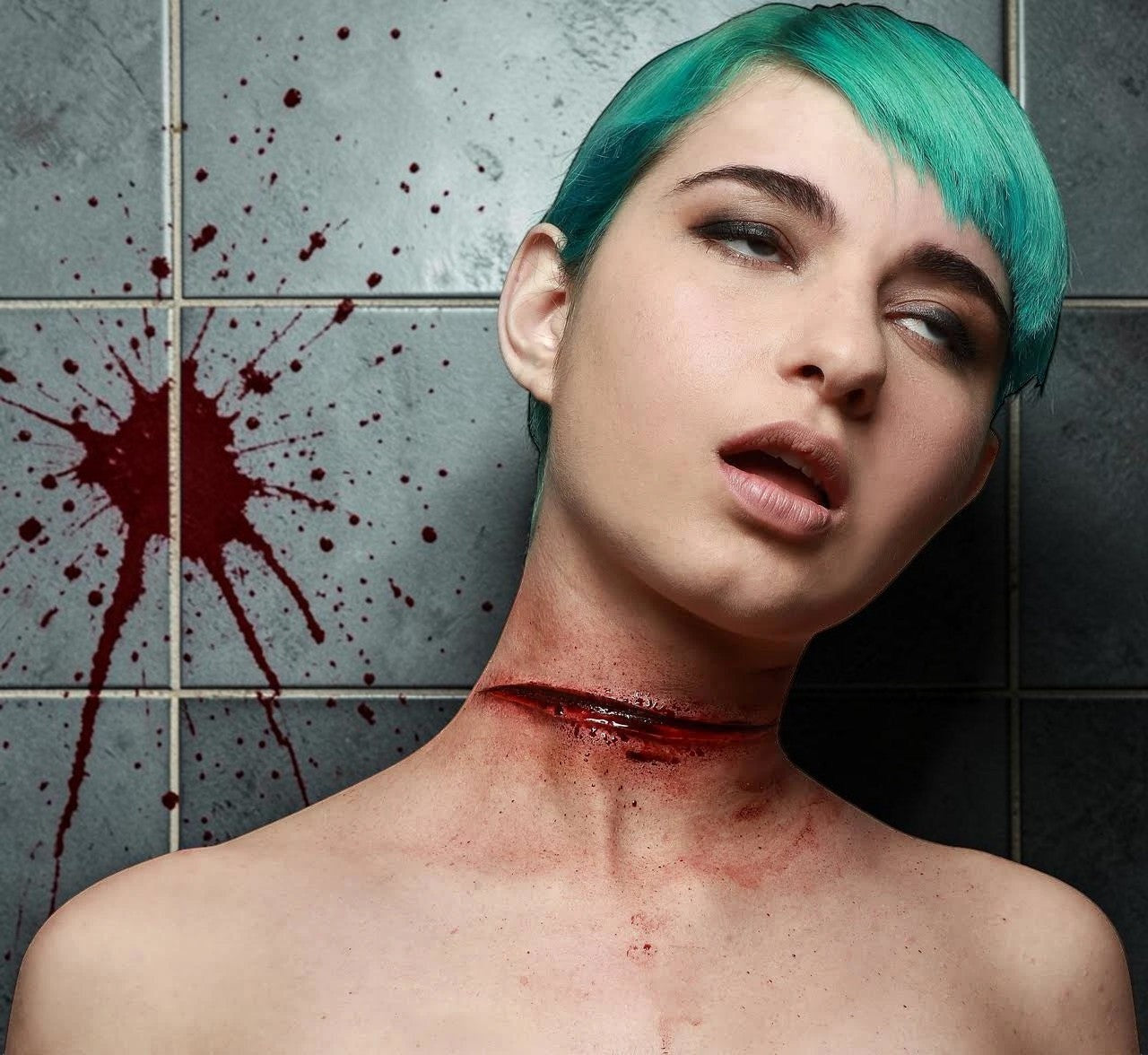 Halloween-Emporium latex slit throat SFX appliance on a model with teal hair against a blood-splattered tiled wall