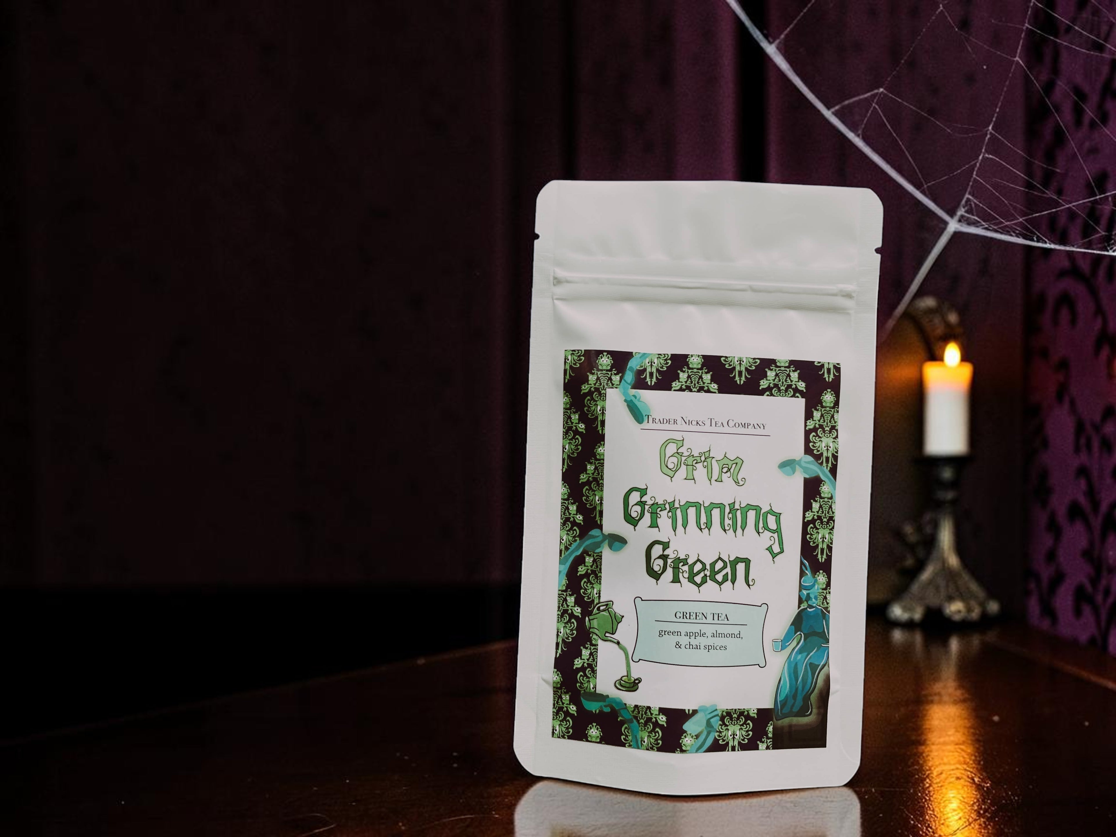 Halloween-Emporium Grim Grinning Green spiced apple green tea pouch with spooky graveyard label in a dark setting