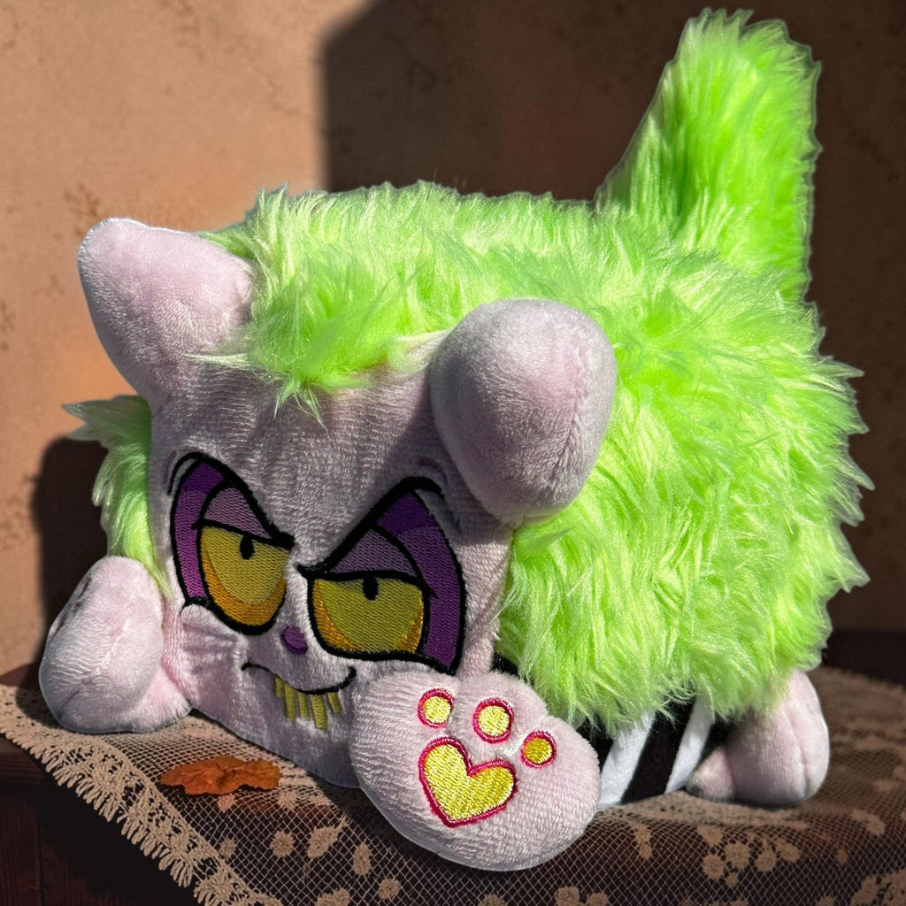 Halloween-Emporium plush throw pillow with neon green faux fur, lavender body, and embroidered grumpy character face.