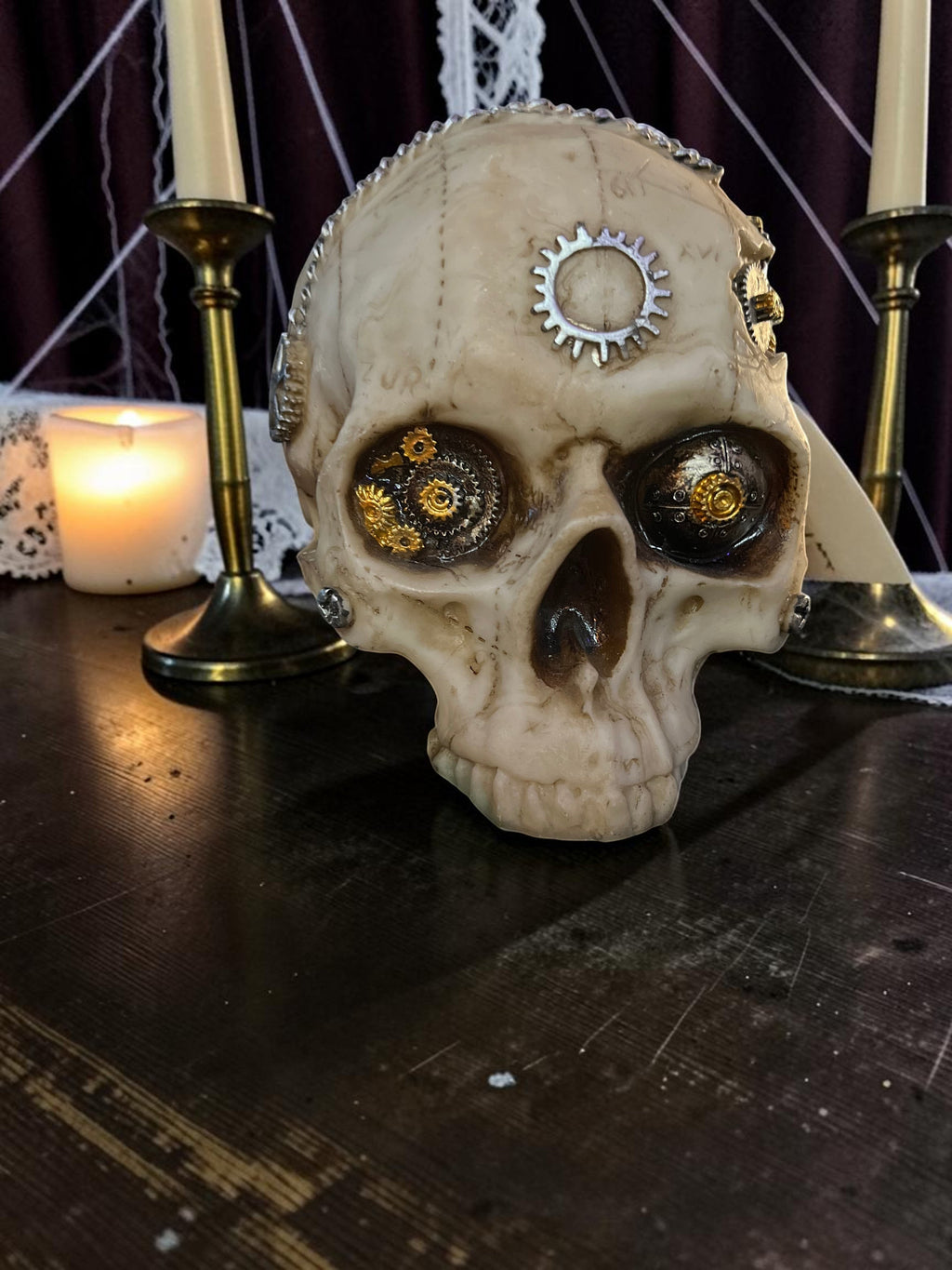 Halloween-Emporium steampunk mechanical human skull decoration with metallic gears and weathered bone finish.
