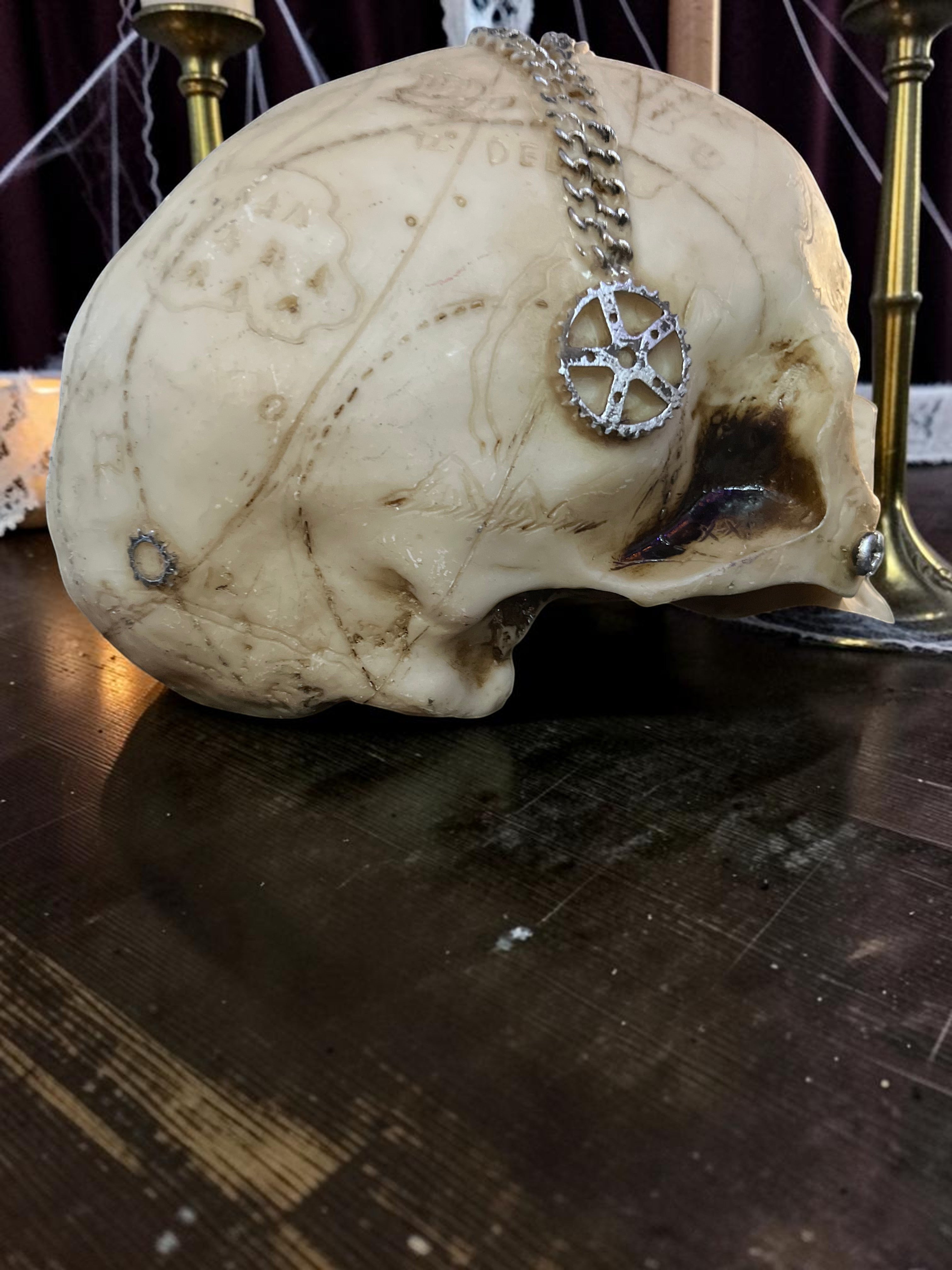 Halloween-Emporium steampunk mechanical skull decoration with aged bone finish and silver gear chain accent