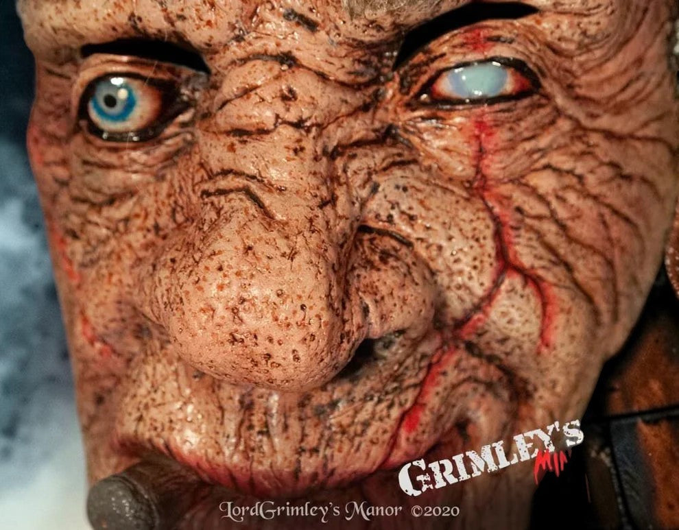 Halloween-Emporium Doctor Thaddeus Tinker latex mask with hyper-realistic weathered skin, scarring, and mismatched eyes