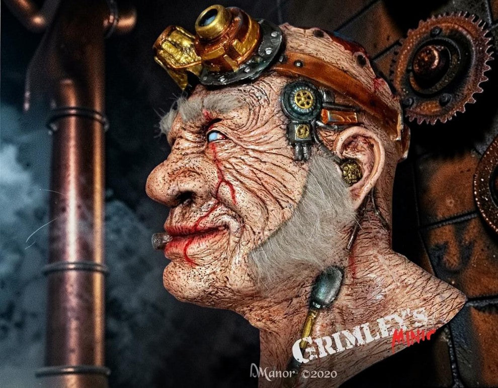 Halloween-Emporium Doctor Thaddeus Tinkers steampunk latex mask with brass goggles and realistic weathered skin texture