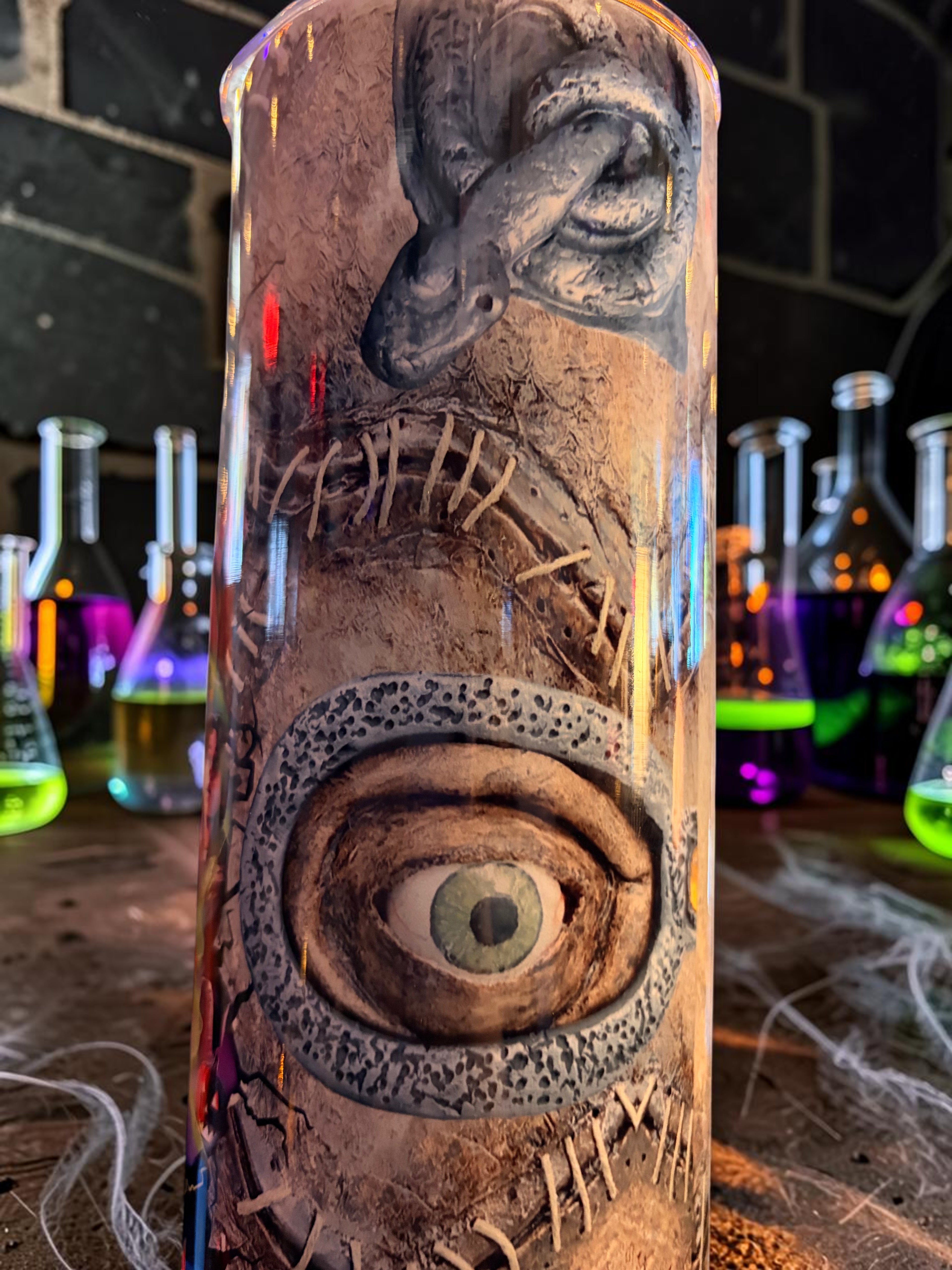 Halloween-Emporium 30oz tumbler featuring a detailed stitched eye and dark-luxe horror aesthetic design