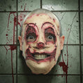 Halloween-Emporium handmade latex serial killer mask with gruesome stitched skin and bloody details on tiled wall