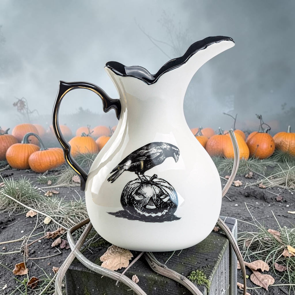 Halloween-Emporium stoneware witches brew pitcher featuring a black raven and jack-o'-lantern design with black interior.