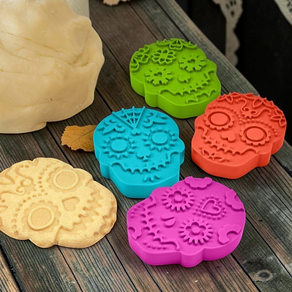 Halloween-Emporium Sweet Spirits sugar skull cookie cutters in green, blue, orange, and pink with embossed details.