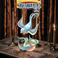 Halloween-Emporium Tattco FX swallow bird temporary tattoos in blue and green vintage sailor styles on a rustic table.