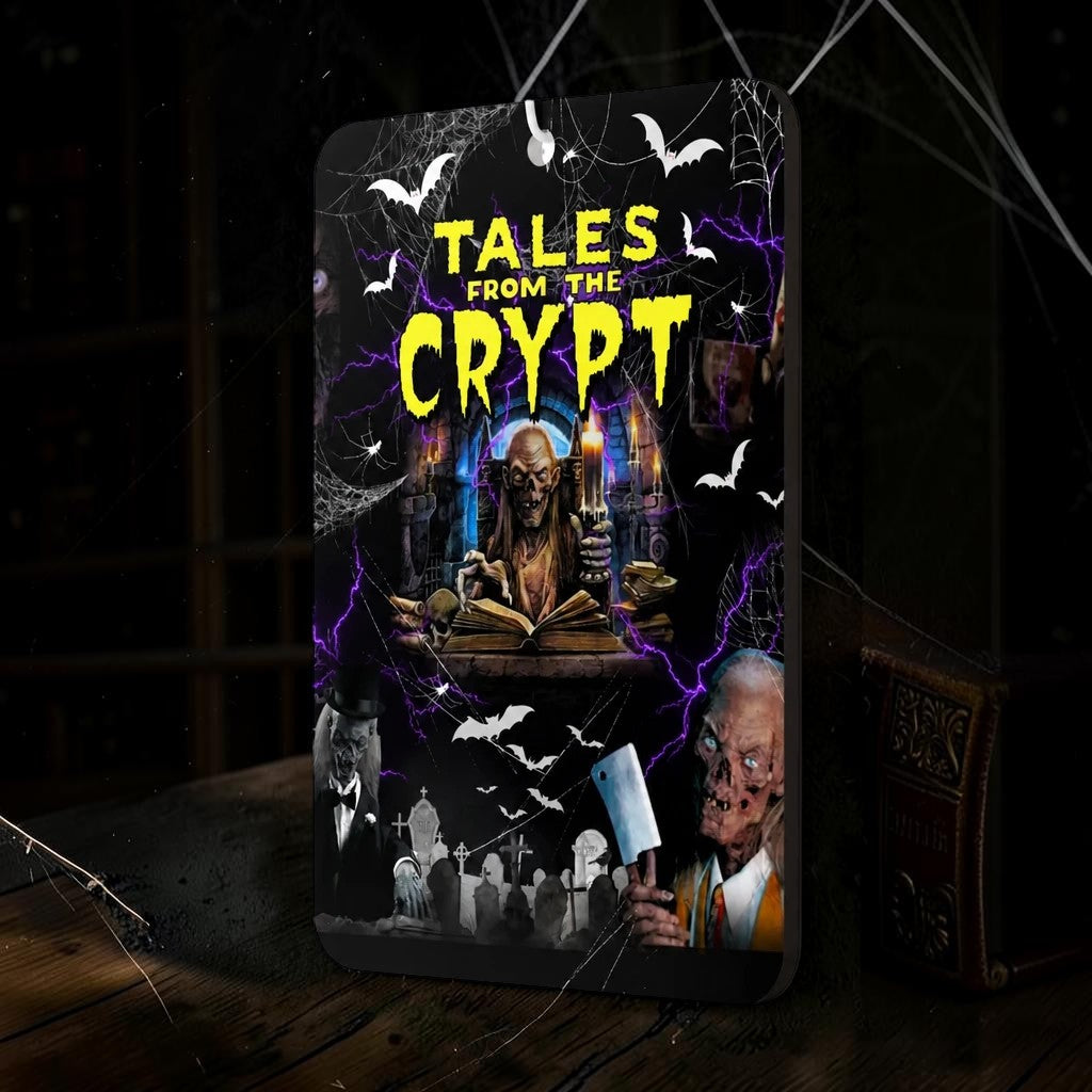Halloween-Emporium Tales from the Crypt honeysuckle car air freshener with horror graphics on a dark wooden table