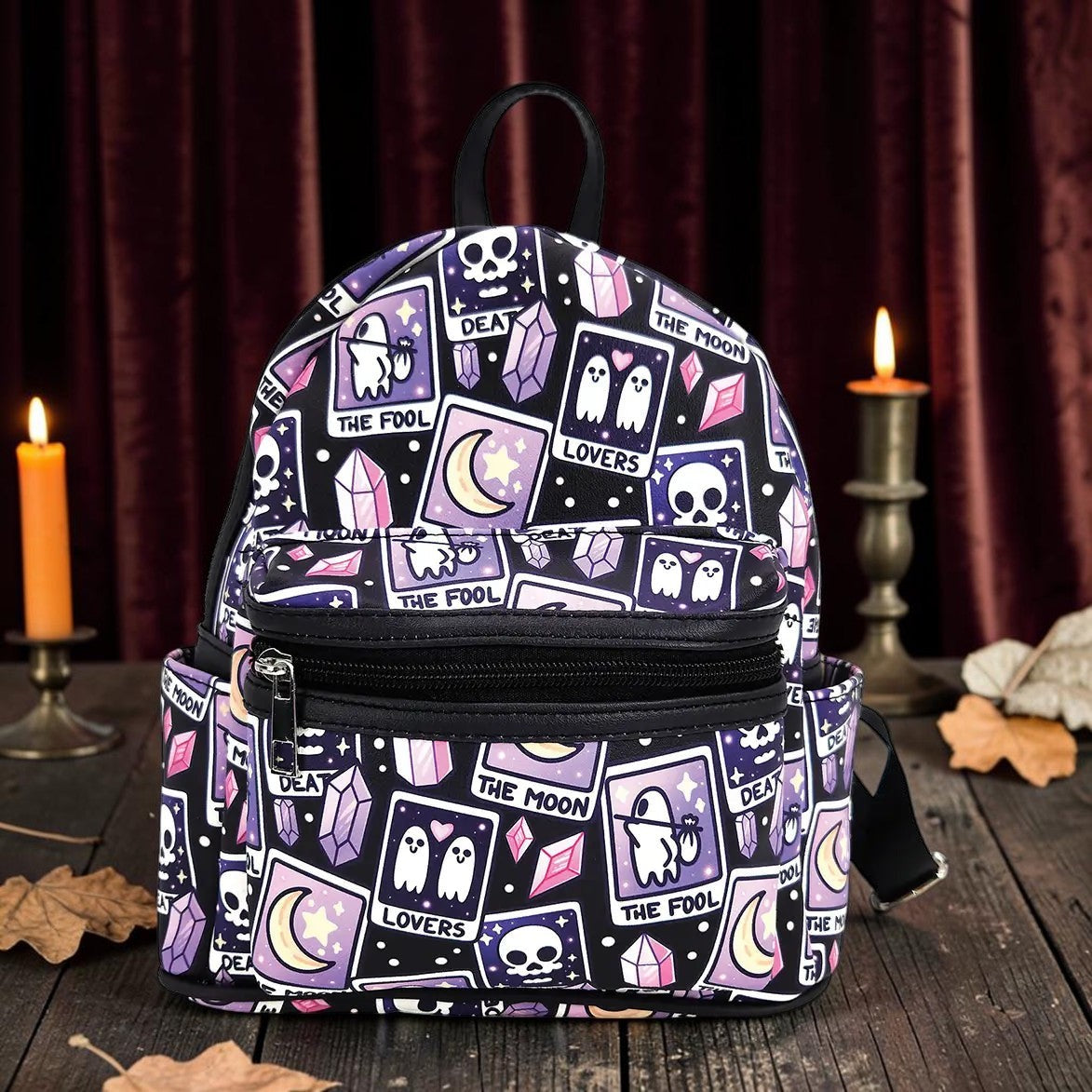 Halloween-Emporium mini backpack featuring a purple and black tarot card pattern with ghosts, skulls, and crystals.