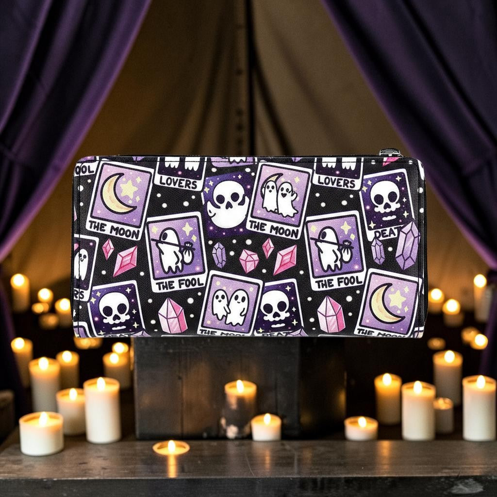 Halloween-Emporium tarot card print vinyl wallet in purple and black with ghost and skull motifs in a candlelit room