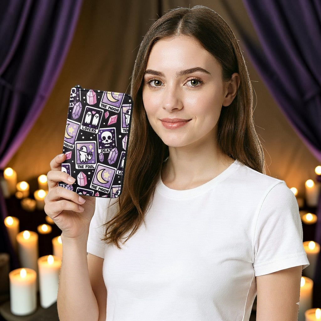 Halloween-Emporium tarot cards vinyl wallet with purple and black mystical pattern held by a woman in a white shirt