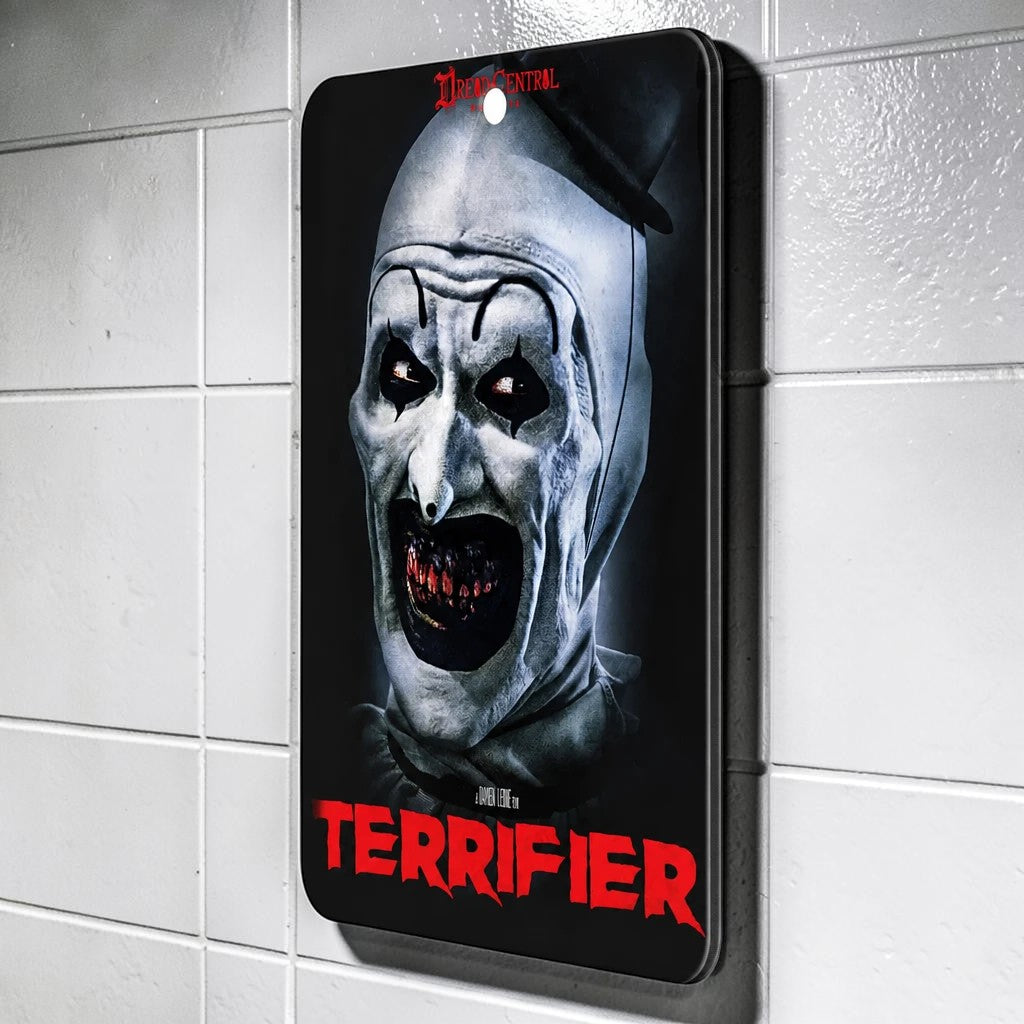 Halloween-Emporium Terrifier air freshener featuring Art the Clown with a coconut vanilla scent hanging on a tiled wall