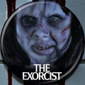 Halloween-Emporium The Exorcist Regan 1.25-inch round pinback button featuring a close-up of the iconic horror character.