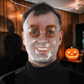 Halloween-Emporium transparent PVC human face mask worn by a man, creating a surreal and uncanny effect.