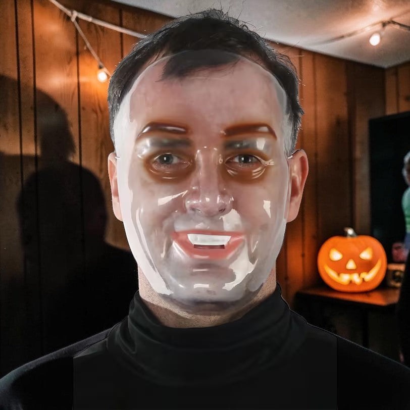 Halloween-Emporium transparent PVC human face mask worn by a man, creating a surreal and uncanny effect.