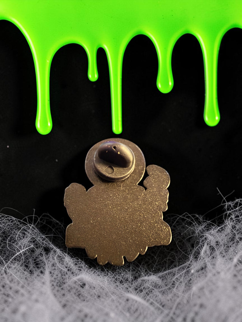 Halloween-Emporium Trick 'r' Treat Sam's Rules of Halloween enamel pin back view on a spooky black and green background