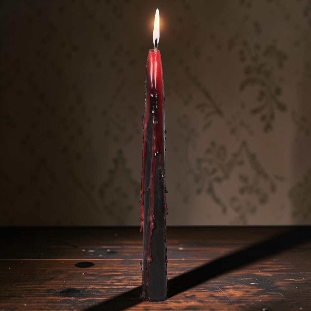 Halloween-Emporium Vampire Tears taper candle with a black exterior melting to reveal a crimson red bleeding wax core.