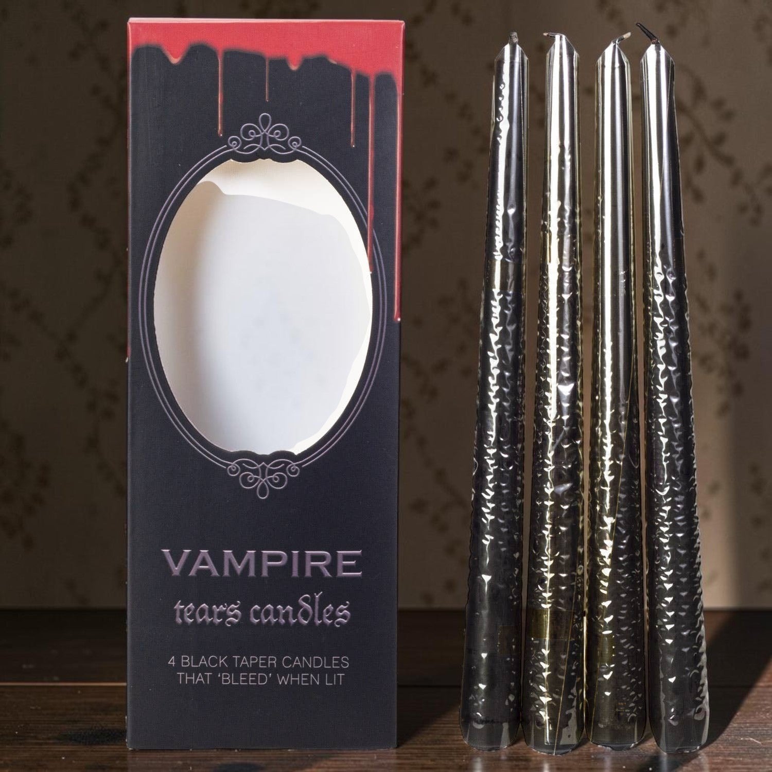 Halloween-Emporium Vampire Tears taper candle set of four black wax candles that bleed red when lit in packaging.
