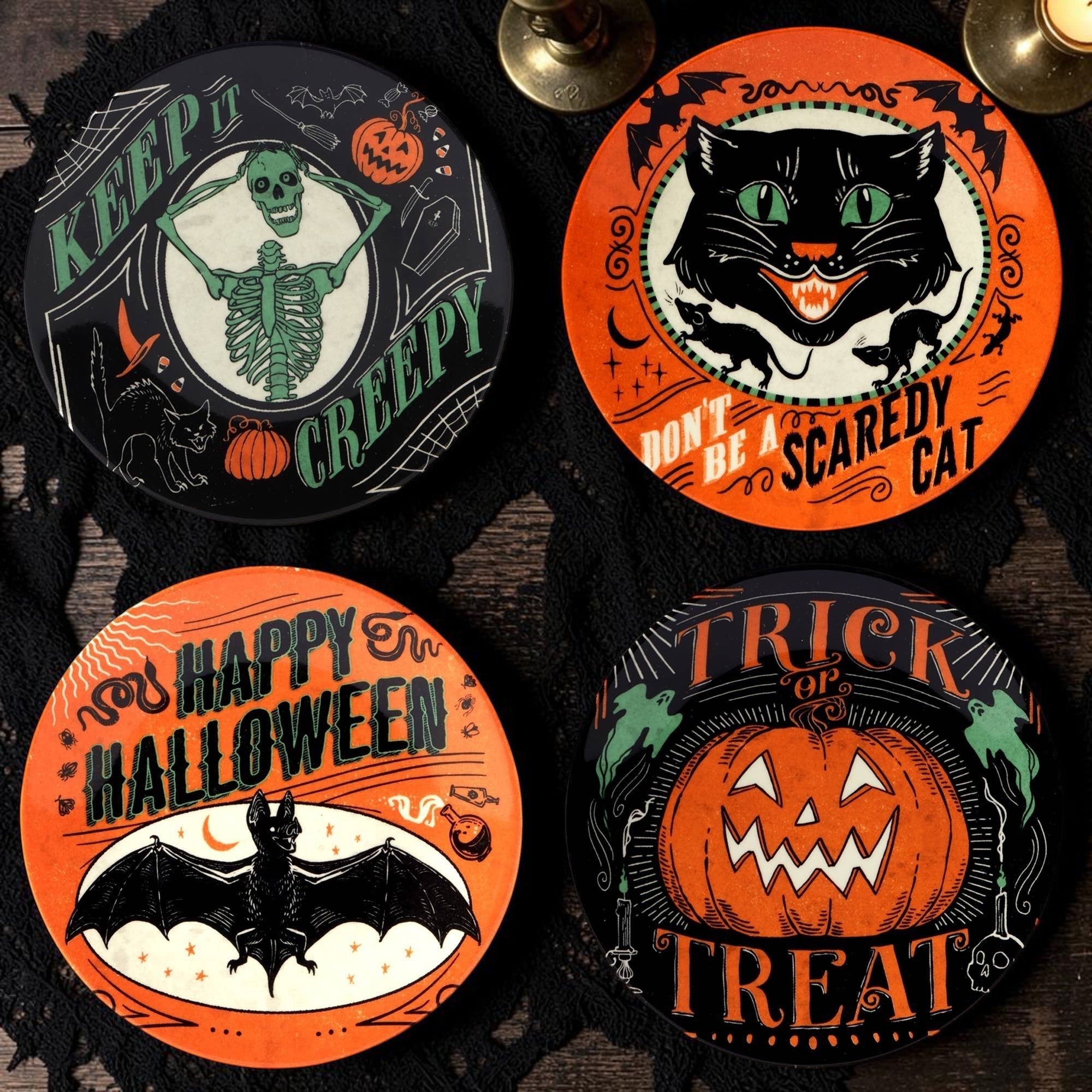 Halloween-Emporium set of four 6-inch round canape plates featuring vintage jack-o'-lantern, cat, skeleton, and bat art.
