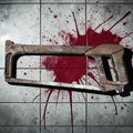 Halloween-Emporium weathered plastic hacksaw prop with a rusted finish, displayed on a blood-splattered tile floor.