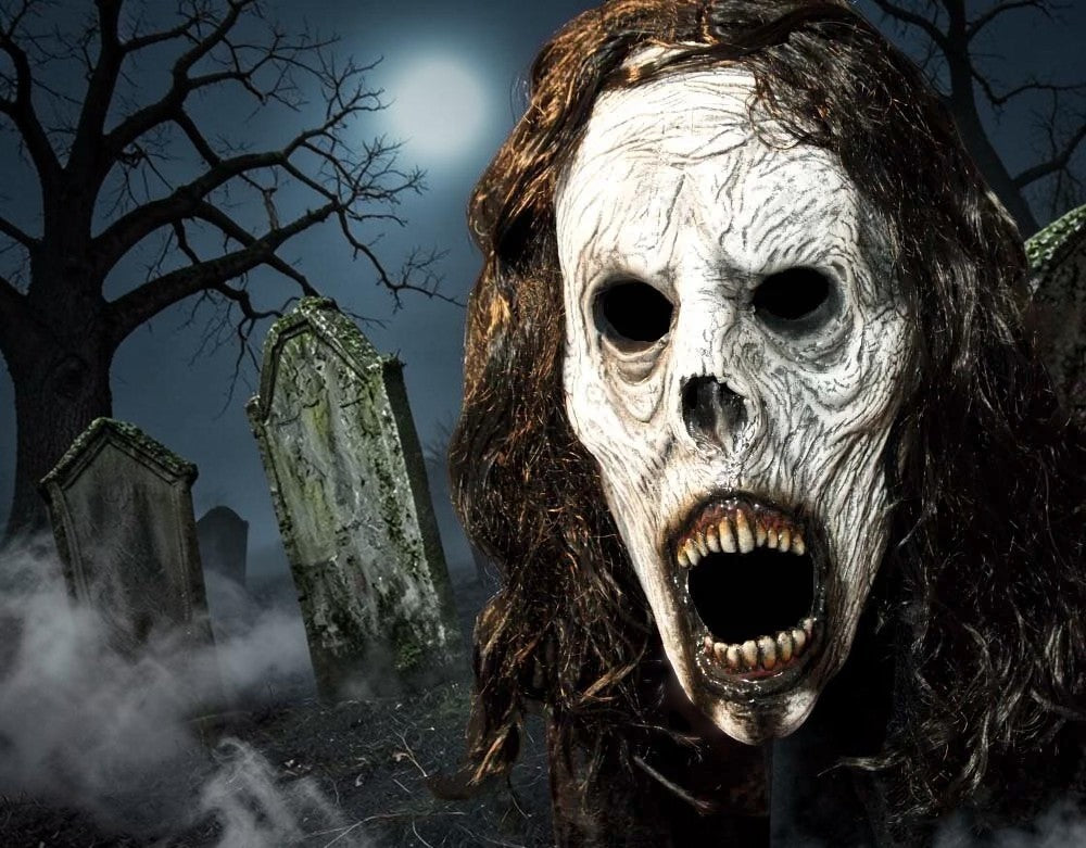 Halloween-Emporium Weeping Wraith half mask with weathered white latex skin, hollow eyes, and dark faux hair in a graveyard