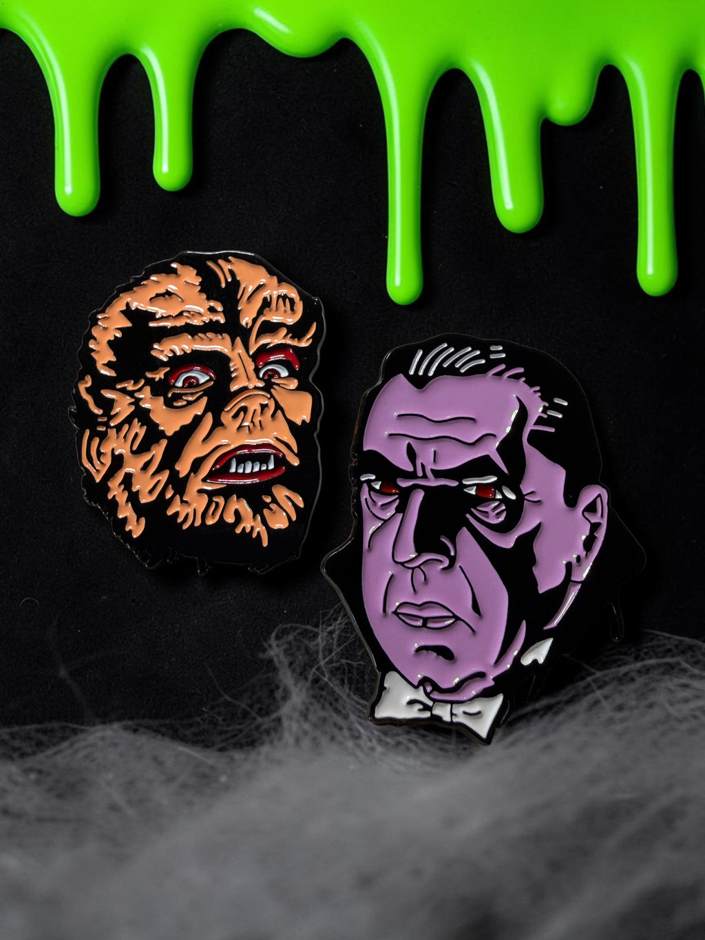 Halloween-Emporium werewolf and vampire soft enamel pins featuring classic horror monster designs on black background