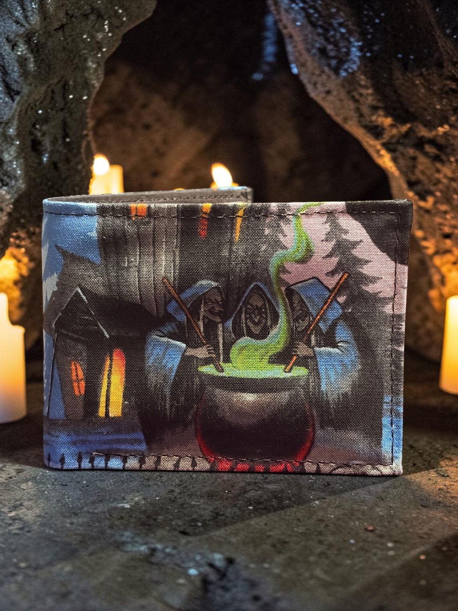 Halloween-Emporium hand crafted wallet featuring a three witches cauldron scene on a dark, candlelit stone background