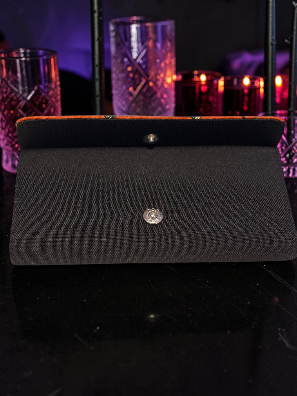 Halloween-Emporium Wolfman clutch wallet in black with a snap button closure, displayed on a dark surface.