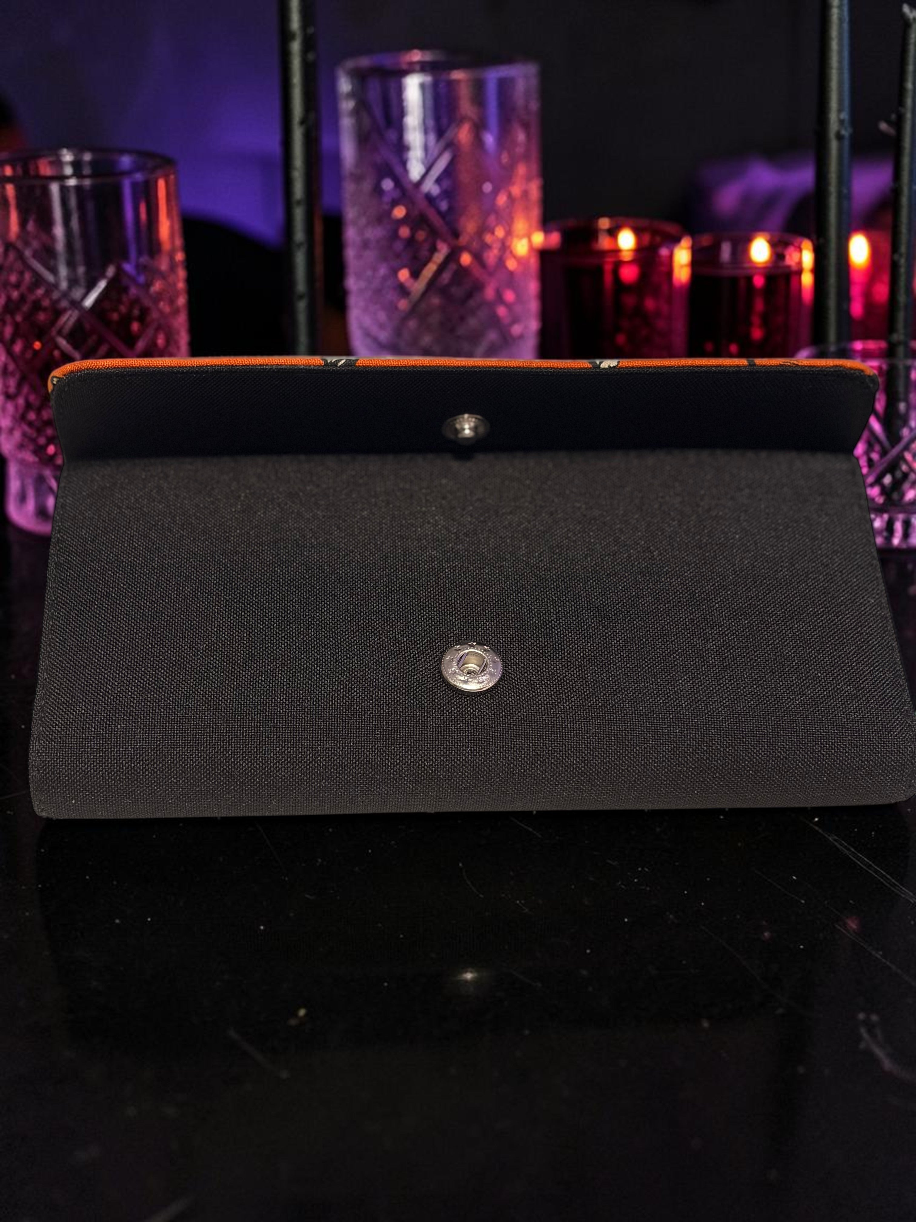 Halloween-Emporium Wolfman clutch wallet in black with a snap button closure, displayed on a dark surface.