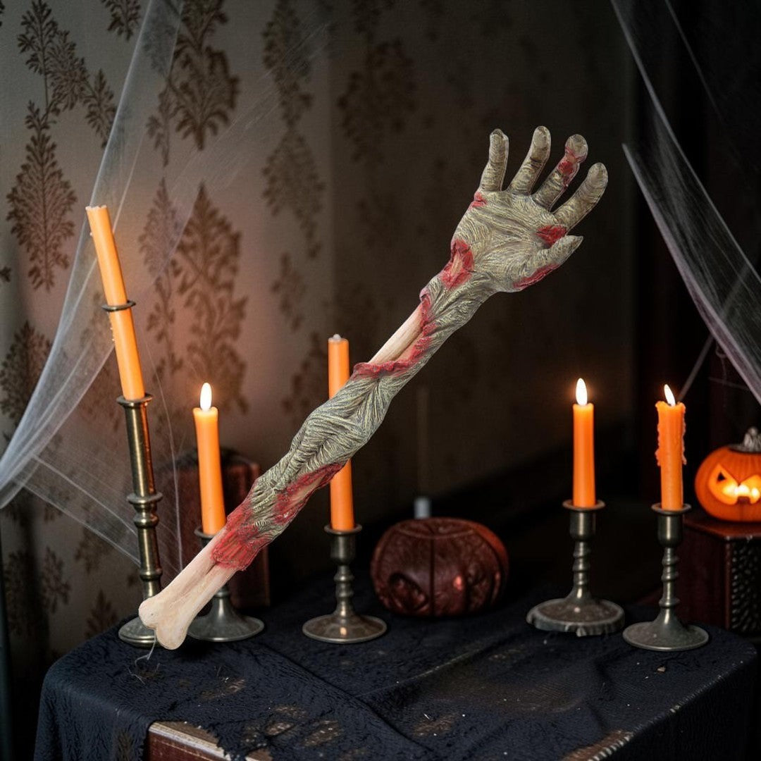 Halloween-Emporium severed zombie arm back scratcher with realistic decaying skin and exposed bone in a spooky setting
