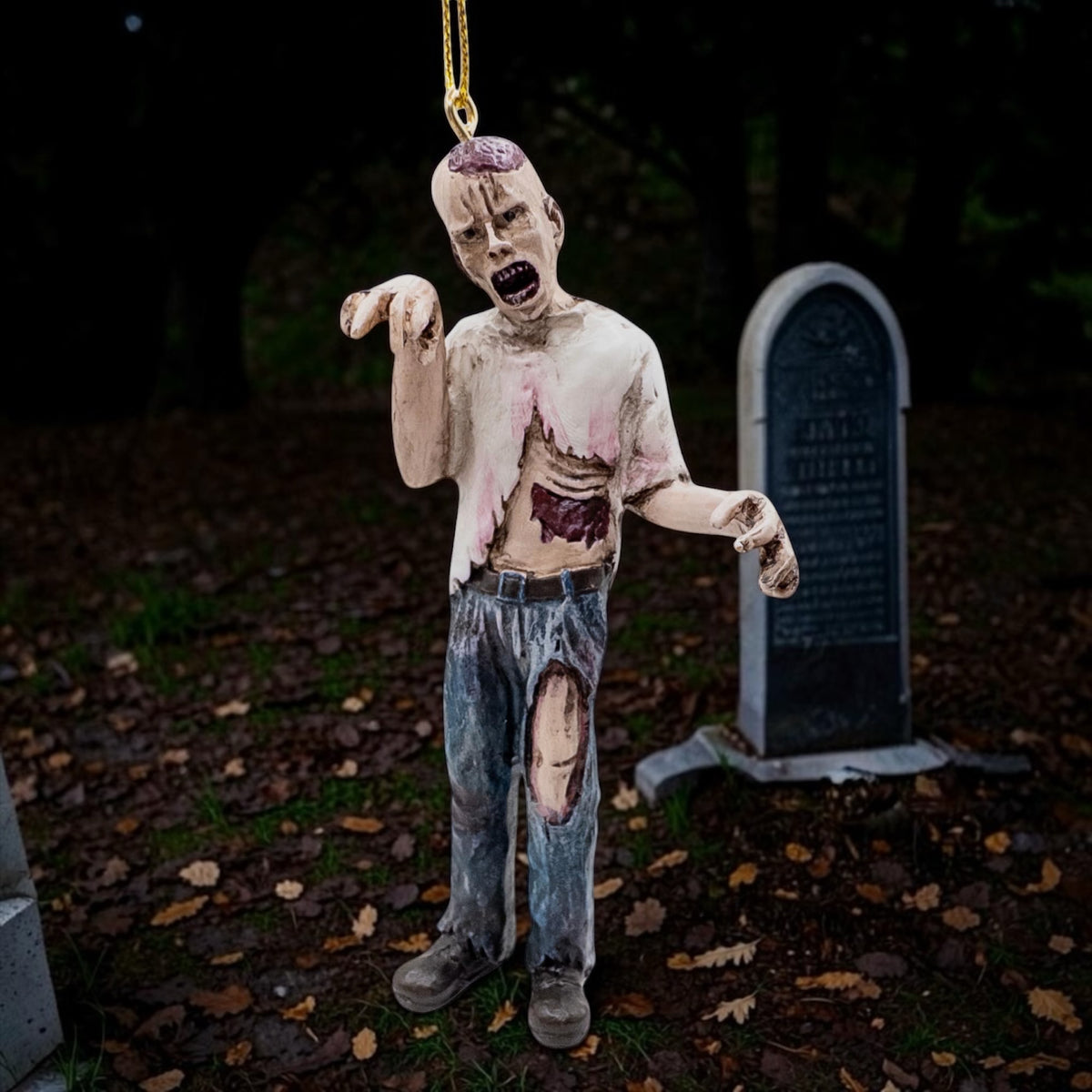 Halloween-Emporium undead zombie hanging ornament with realistic tattered clothing and gory details.