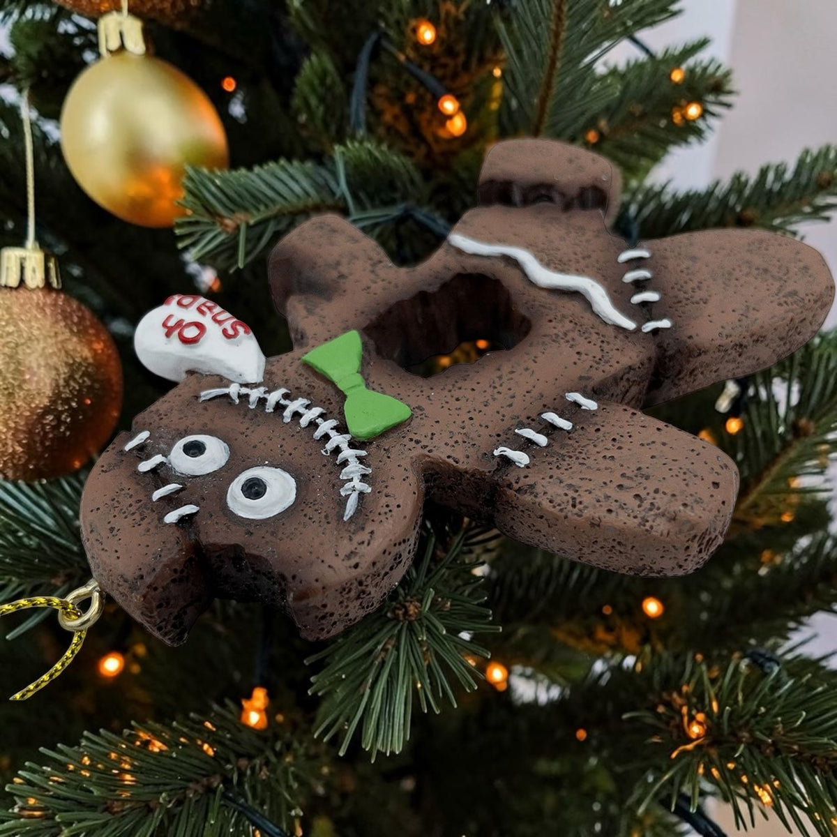 Halloween-Emporium spooky gingerbread man ornament with stitched details, green bow tie, and Oh Snap speech bubble.