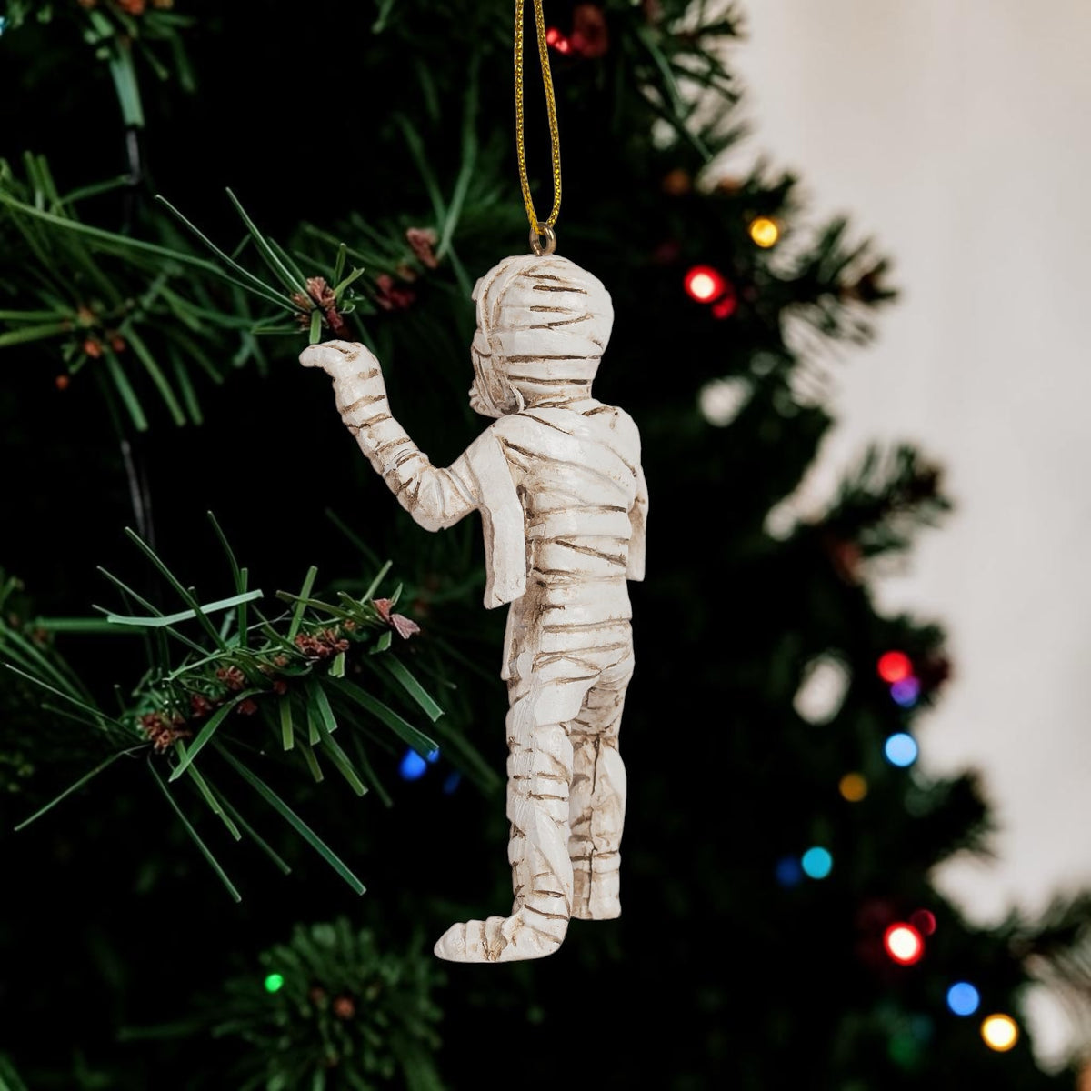 Halloween-Emporium mummy hanging ornament with detailed bandages, displayed on a festive Christmas tree.