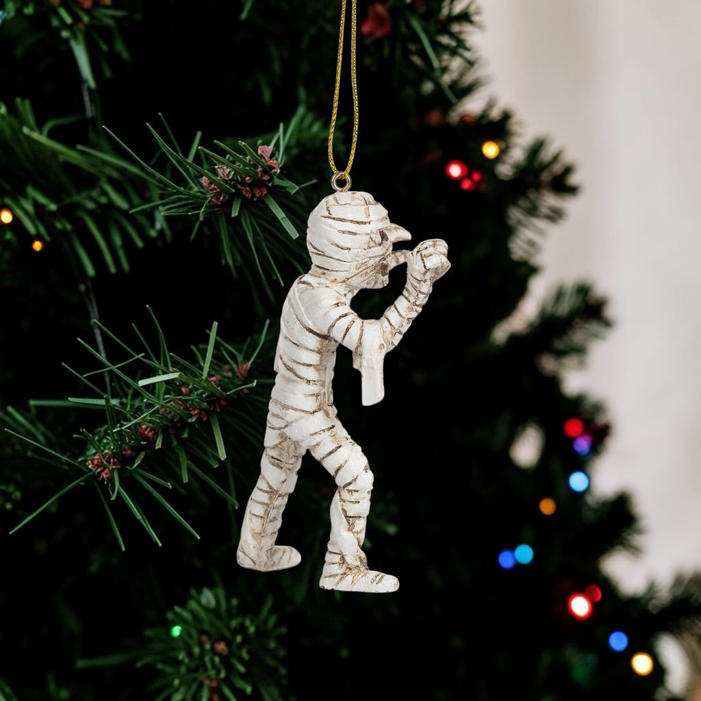 Halloween-Emporium mummy hanging ornament with detailed white bandages on a festive Christmas tree.