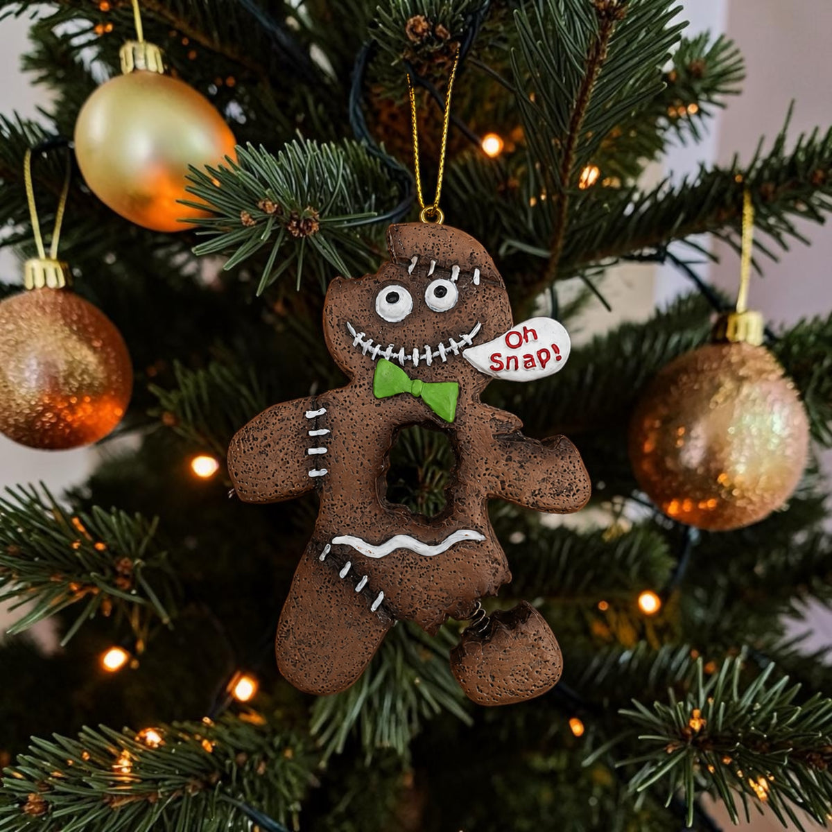 Halloween-Emporium spooky gingerbread man ornament with stitched details, green bow tie, and Oh Snap speech bubble.