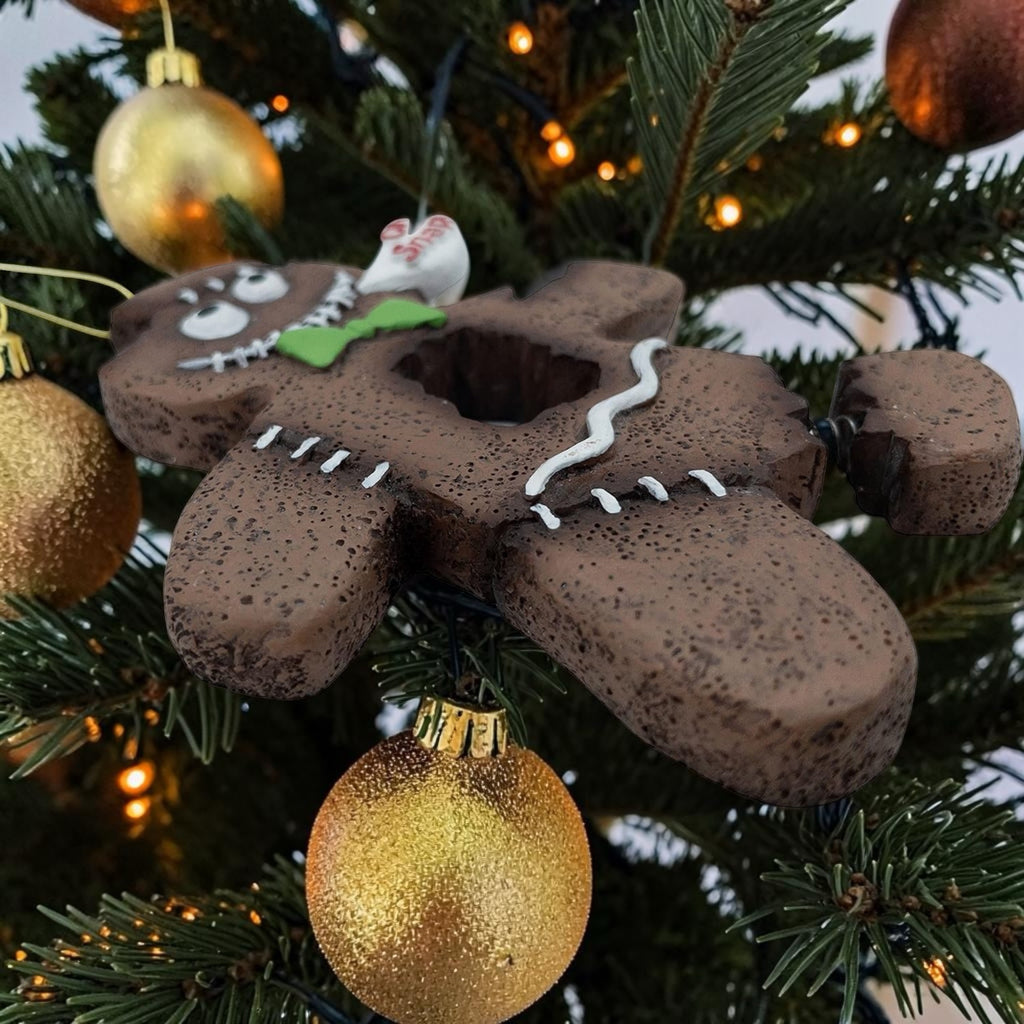Halloween-Emporium spooky gingerbread man ornament with a green bow tie and Oh Snap speech bubble on a Christmas tree.