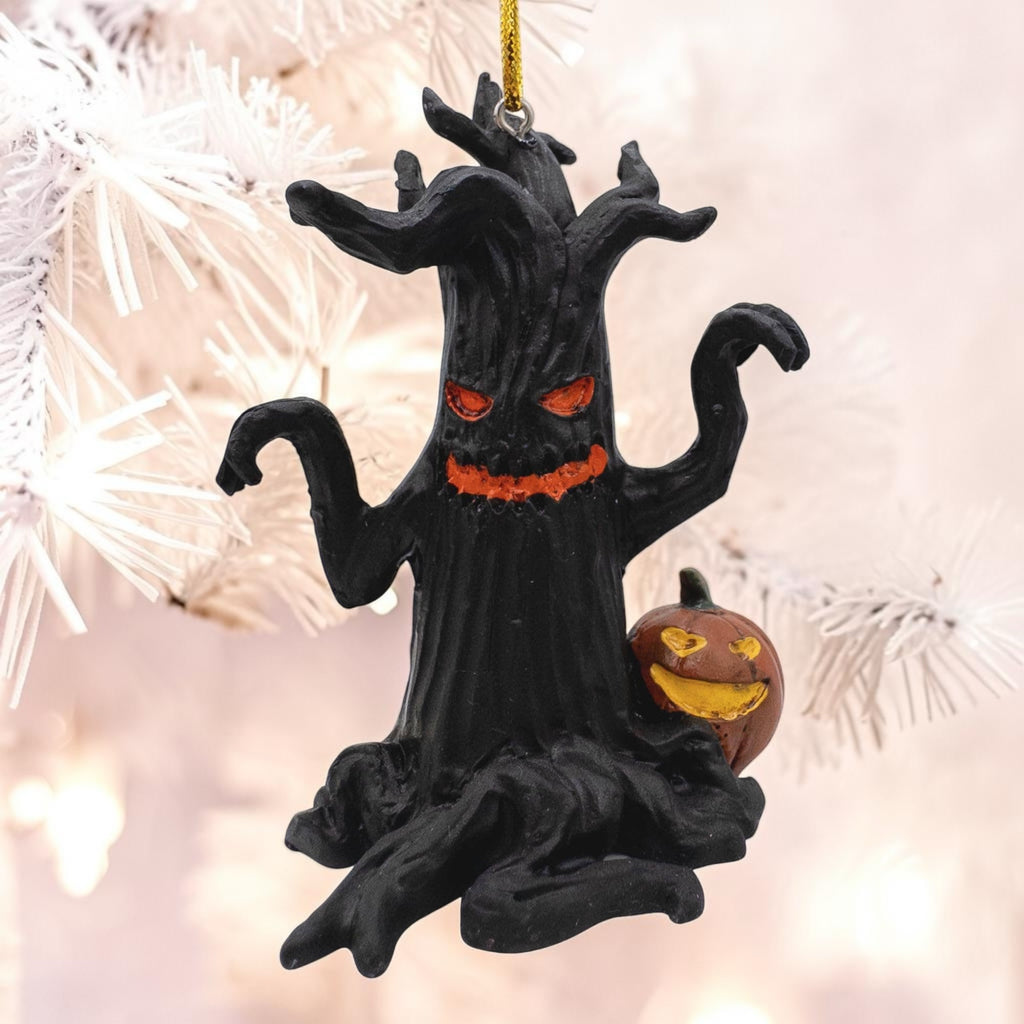 Halloween-Emporium black haunted tree ornament with glowing orange eyes and a jack-o-lantern on a white tree branch.