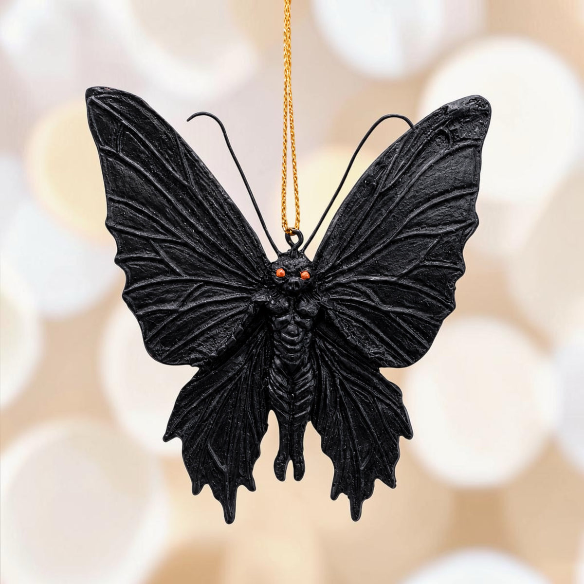 Halloween-Emporium black gothic mothman hanging ornament with textured wings and piercing red eyes.