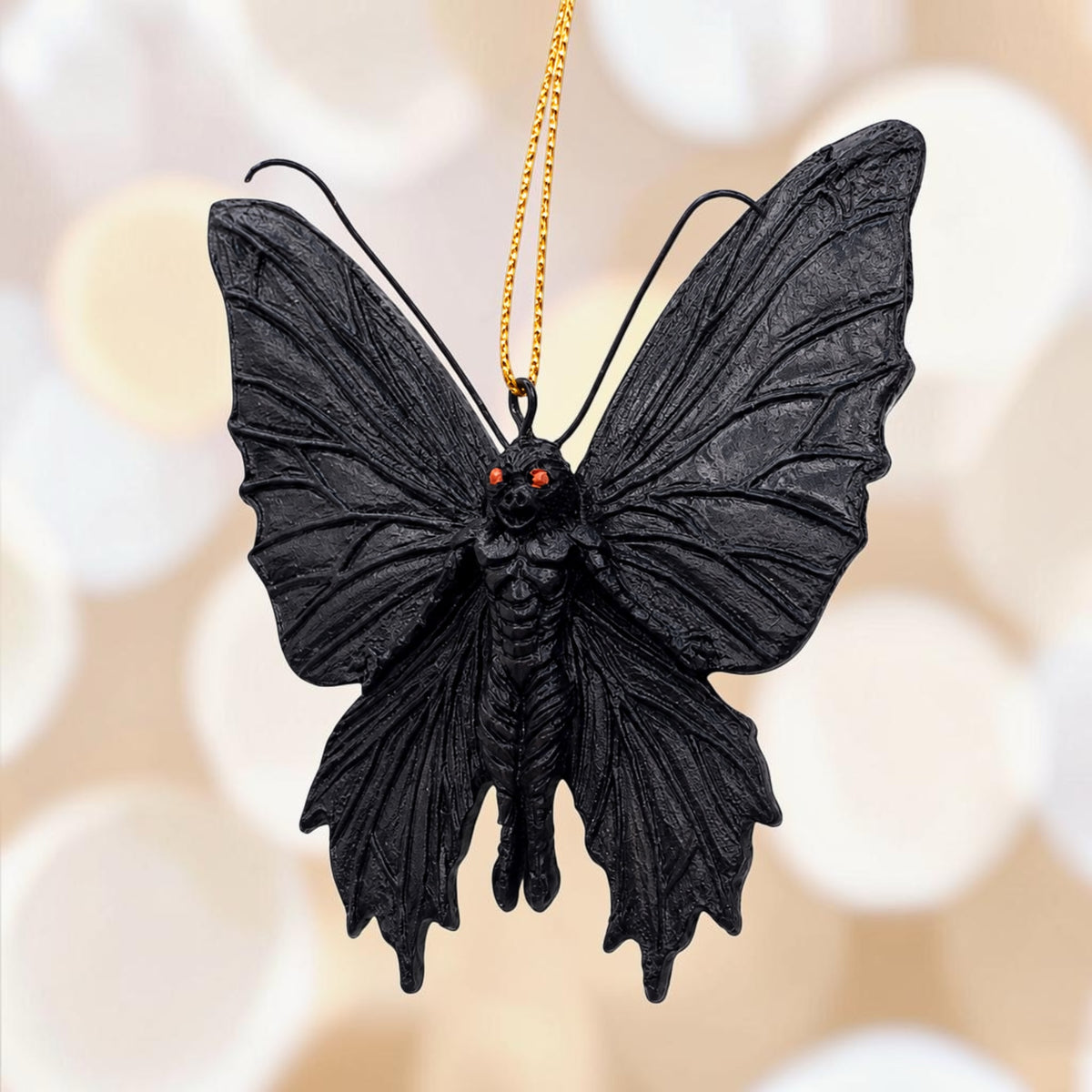 Halloween-Emporium black mothman hanging ornament with intricate textured wings and glowing red eyes.
