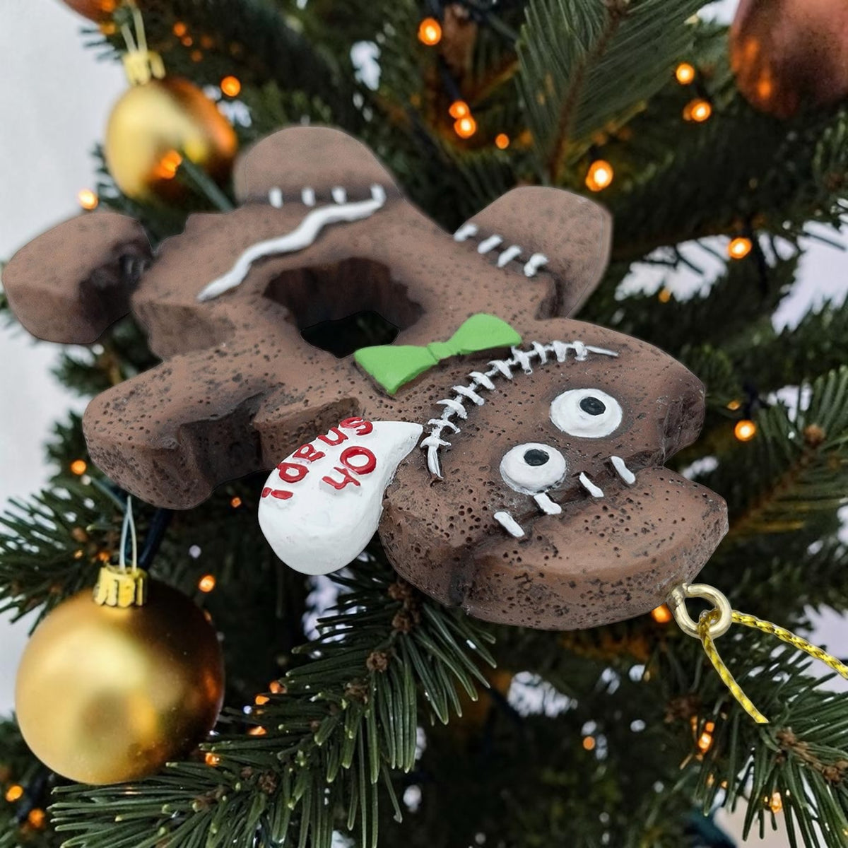 Halloween-Emporium spooky gingerbread man ornament with stitched details, green bow tie, and Oh Snap speech bubble.