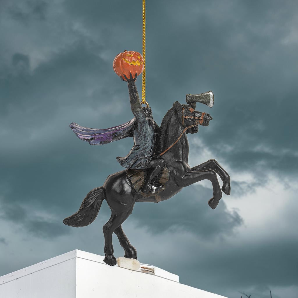 Halloween-Emporium Headless Horseman ornament featuring a rider on a black horse holding a glowing jack-o'-lantern.